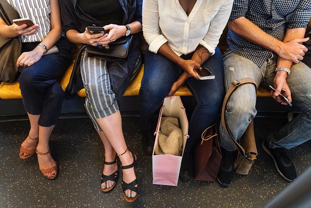 people watching video content while sitting down on a train.