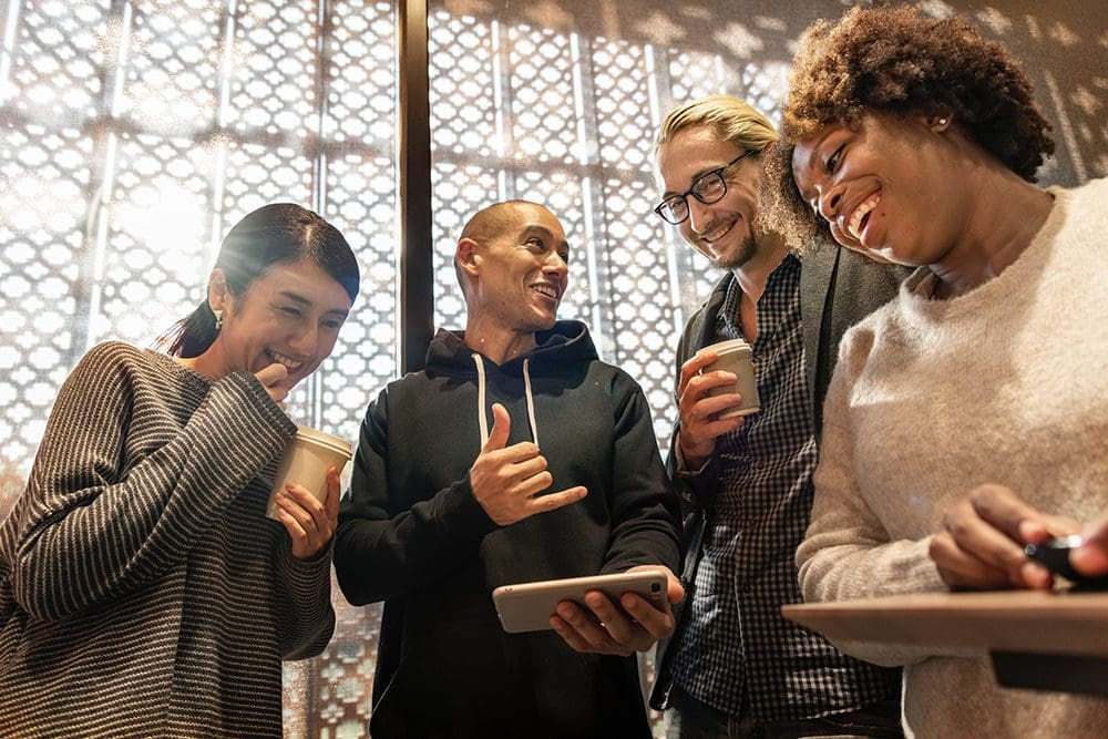 People gathered around devices watching viral videos