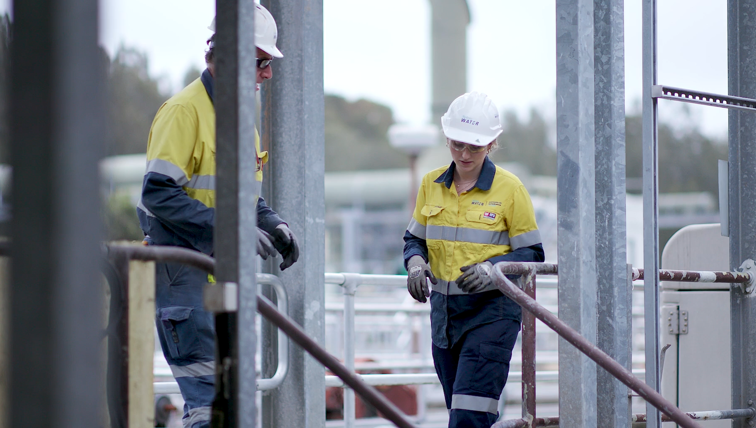 Water infrastructure worker walking on schaffolding Water infrastructure worker walking on scaffolding
