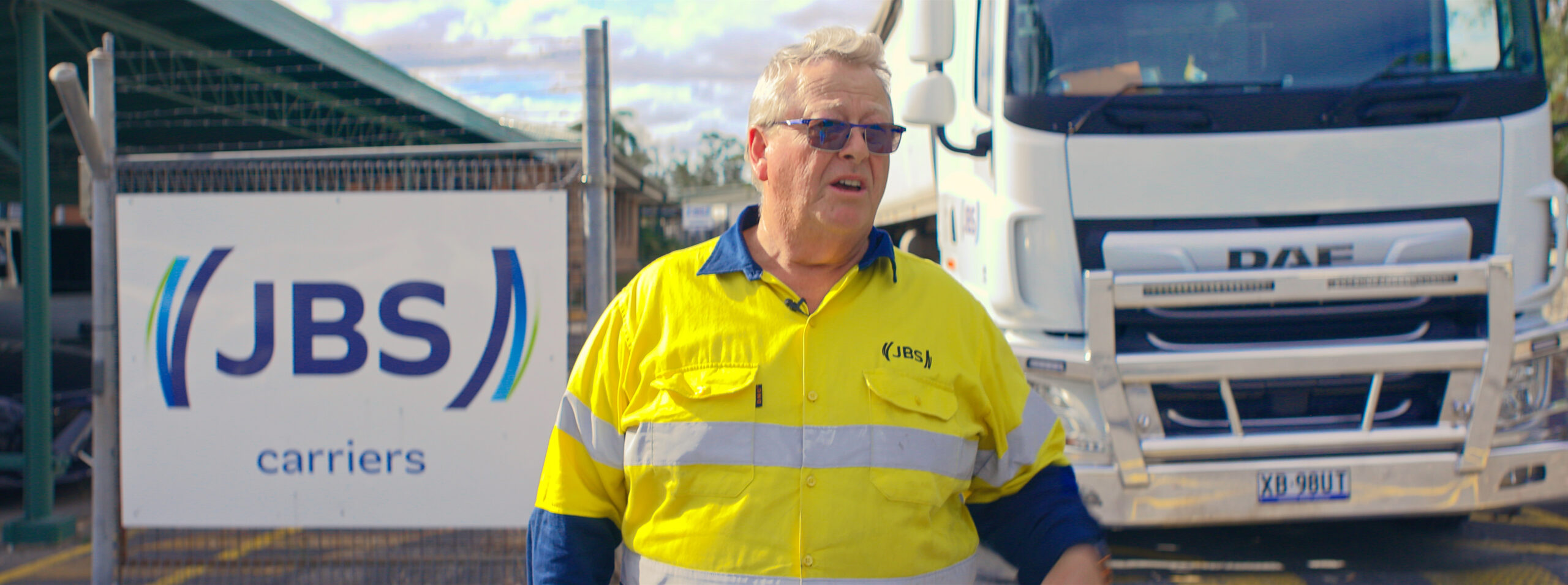 Timeline 1_01_00_48_12 Man standing in front of truck at workplace
